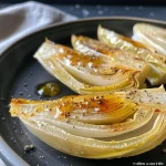Close-up view of braised endives showcasing a golden-brown texture.