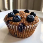 Close-up view of quinoa protein muffins with chocolate chips and blueberries.