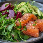 Close-up view of a vibrant roasted salmon detox salad with fresh vegetables and avocado.