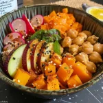 A vibrant bowl filled with quinoa, grilled vegetables, and feta cheese.