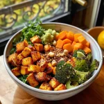 Close-up view of a vibrant Buddha Bowl filled with butternut squash, Brussels sprouts, and chickpeas.